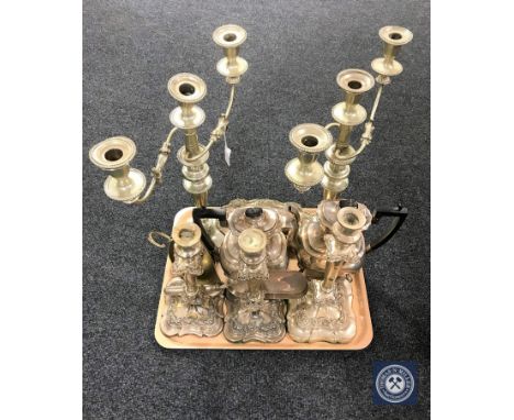 A tray of 20th century plated wares including a pair of three-way candelabra, three candle sticks, two coffee pots etc