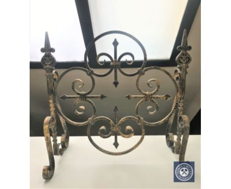 A wrought iron fire screen