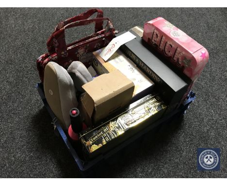 A basket of toiletries, beauty products, hair brush, Cath Kidston bag, storage caddy, wicker basket and a picture frame 