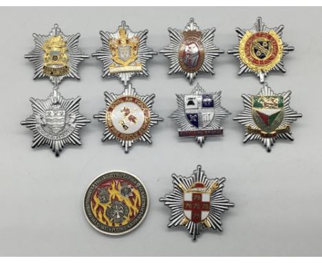 A selection of vintage chromed and enamelled fire service cap badges, and a RAF Lakenheath 48th Fighter Wing Coin. To include