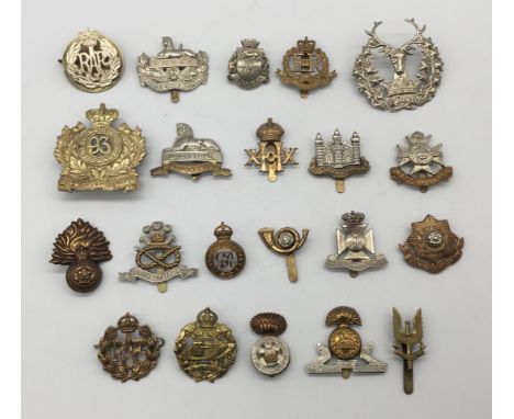 A quantity of WW1, WW2, and later British regimental cap badges. To include: a post WW2 military police, a post WW2 RAF badge