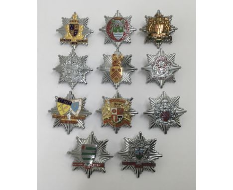 A selection of vintage chromed and enamelled fire service cap badges. To include: Cumberland Fire Service, Walsall Fire Briga