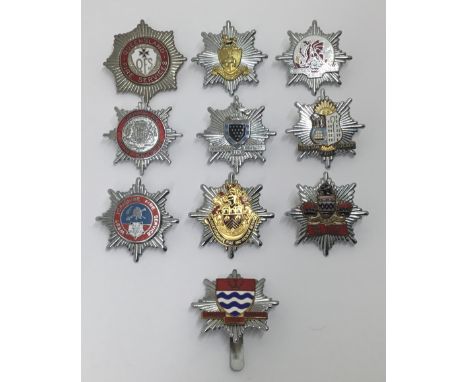 A selection of vintage chromed and enamelled fire service cap badges. To include: Powys Fire Service, Queensland Fire Service