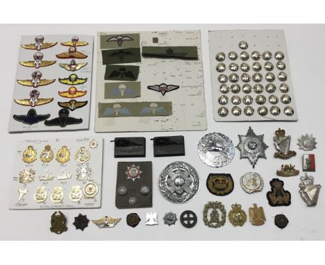 A selection of various military badges, and other items. To include: a board containing modern cap badges for the Australian 