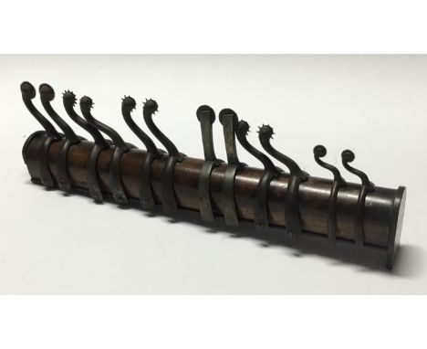 A scarce 19th century military spur shop display piece, containing 6 matched pairs of steel boot spurs of varying styles and 