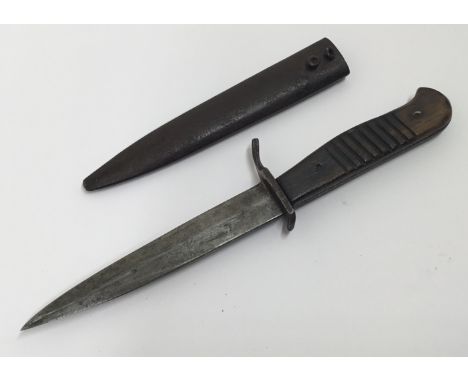 A WW1 era, German trench or boot knife. Of standard form, with shaped wooden slab grips, with each side having the distinctiv