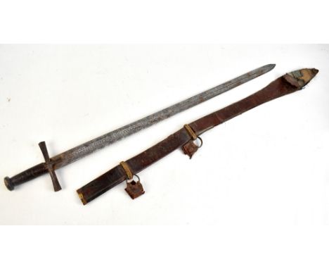 A Sudanese kaskara, the fullered blade with engraved Arabic script to both sides, length of blade 82cm, with cross hilt in le