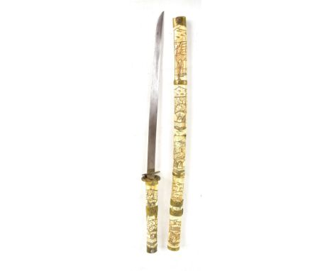 A Japanese bone handled wakizashi with brass mounts featuring stylised mon, length of blade 43.5cm (probably ground down), in