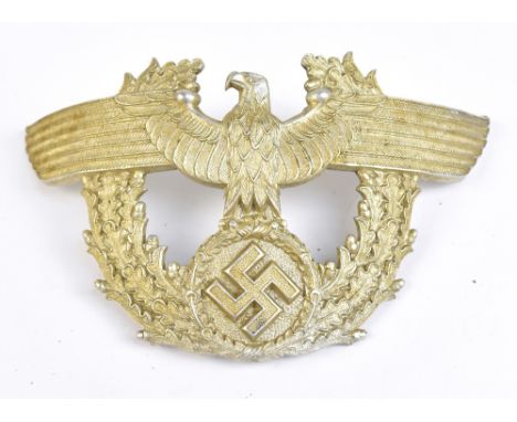 A German WWII Third Reich Police shako plate in aluminium with two screw post fittings, width 13.5cm, height 8cm, sold with a