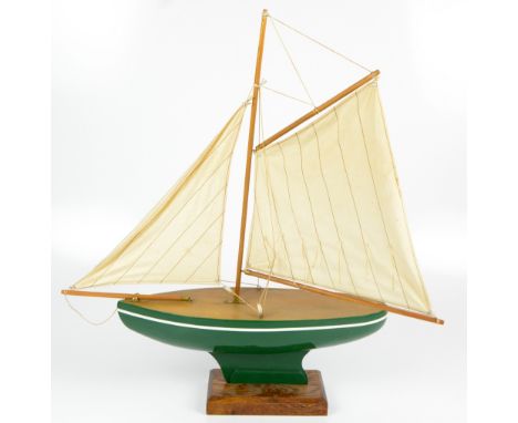 A mid-20th century green painted pond yacht raised on oak plinth base, height 65cm.Additional InformationGeneral wear, light 