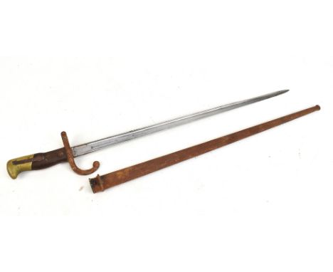 A late 19th century French bayonet, the blade back signed and dated 1879, length of blade 52cm, with scabbard (for restoratio