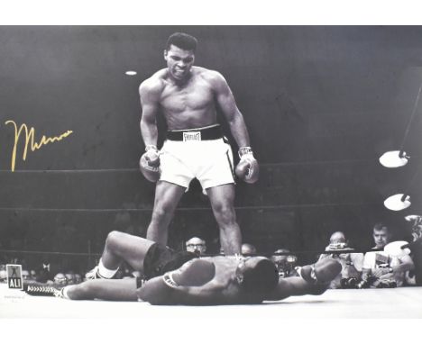 MUHAMMAD ALI; a signed Photofile photograph depicting Ali standing over Sonny Liston after a knock down, May 1965, 74 x 99cm,