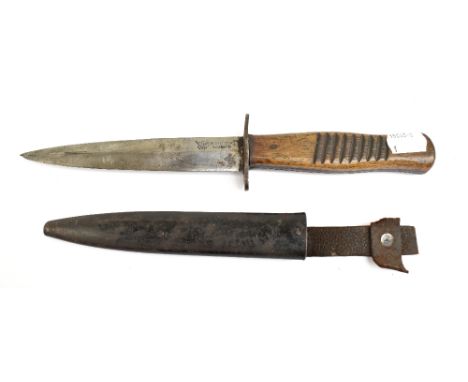 A German WWI trench fighting knife, the blade signed 'Hugo Koller Solingen' with eagle logo, to part textured walnut grip, le