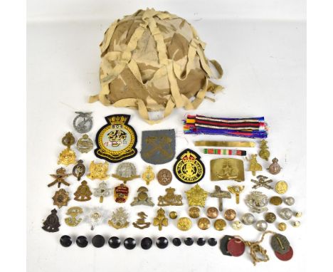A collection of cap badges including Royal Army Ordnance&nbsp;Corps, Royal Artillery, Notts &amp; Derby, National Defence&nbs