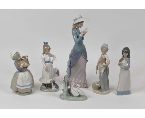 A Lladro porcelain figure of a lady, shown standing reading a book, h.35cm; together with five Nao porcelain figures (6)