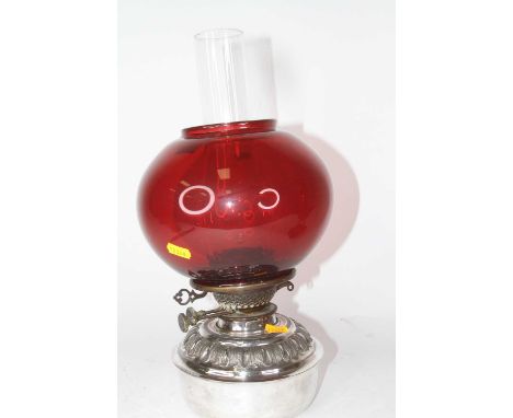 A Victorian oil lamp, having a plated metal reservoir, bayonet Messengers Patent burner, with later ruby glass shade, h.29cm