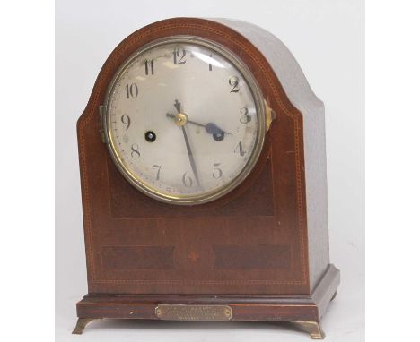 An early 20th century walnut and inlaid dome top mantel clock, the silvered dial with Arabic markers and twin winding holes f