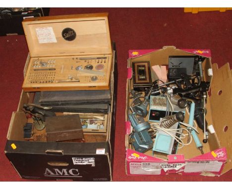 A collection of vintage engineering tools, to include soldering irons, flat pushers, and presses 