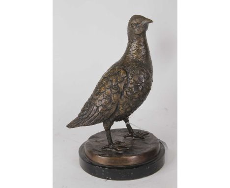 A bronzed metal model of a partridge, shown standing on naturalistic base and mounted to a polished hardstone plinth, h.25cmO