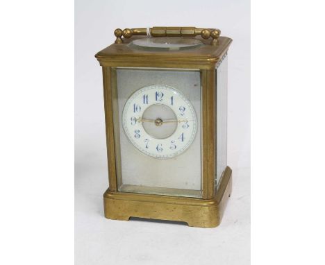 A brass carriage clock, the enamelled chapter ring showing Arabic numerals, having visible platform escapement, h.14cm 