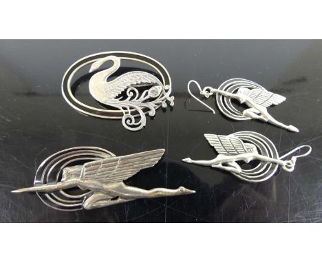 An Art Deco style silver brooch as a winged maiden, together with matching ear pendants; one other Deco style silver brooch f