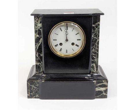 A Victorian black slate mantel clock, having an enamelled dial showing Roman numeral markers and twin winding holes for an ei