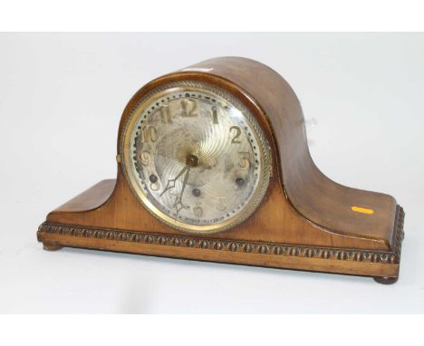 An early 20th century walnut cased mantel clock, the brushed metal dial with applied Arabic markers, having three winding hol