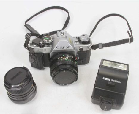 A Canon AE1 SLR camera; together with various accessories 