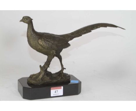 A bronzed metal model of a pheasant, shown standing on naturalistic base, mounted to further canted rectangular hardstone pli