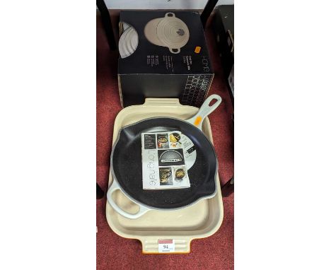 A small collection of cookware, to include Le Creuset enamelled cast iron skillet, cast iron casserole dish, Le Creuset stone