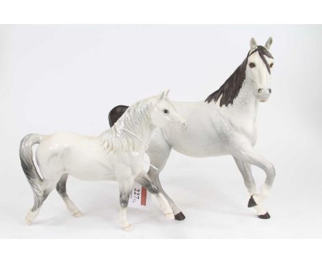 A Royal Doulton model of a Welsh mare, h.16.5cm; together with another Royal Doulton model of a horse; and two similar Beswic