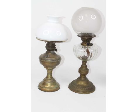 A Victorian oil lamp, having a frosted glass shade over brass burner, clear glass reservoir on pressed metal base, h.52cm; to