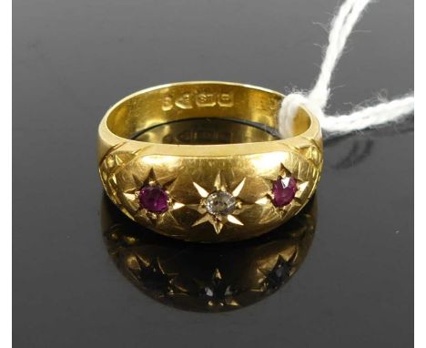 An 18ct gold, ruby and diamond ring, arranged as three 'gypsy' set round cut stones, 2.9g, size O