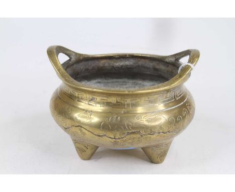 A Chinese brass tripod censer, decorated with a phoenix, w.13cm 