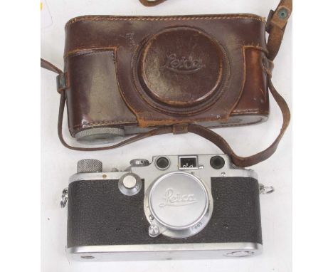 A vintage Leica SLR camera, No. 512585, with leather case