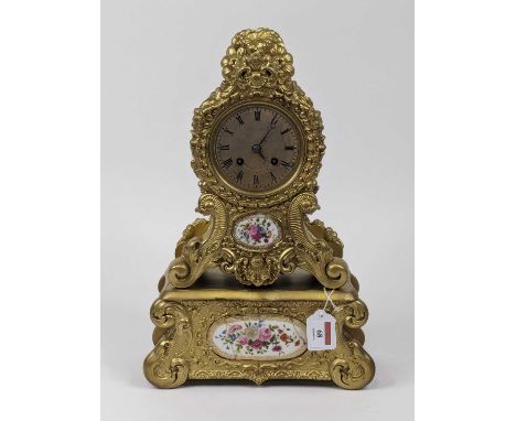 An early 20th century French mantel clock in the Louis XVI style, having a later gilt painted case with inset floral painted 