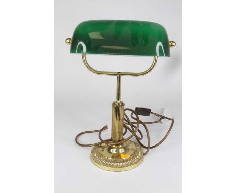 An early 20th century style brass banker's desk lamp, having a green glass shade, height 34cm