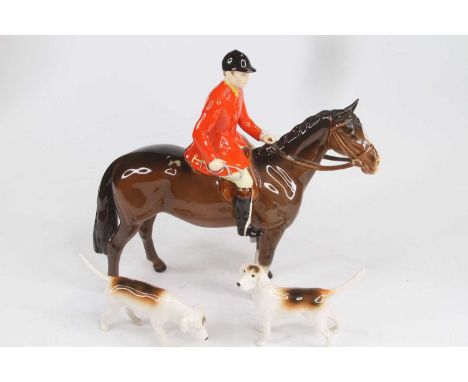 A Beswick model of a huntsman on horseback, model No. 1501, h.20cm; together with two Besiwck hunting houndsAppears free of d