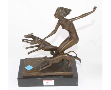 An Art Deco style bronzed metal figure group of a nude woman and three hounds, mounted to a polished hardstone plinth, h.24cm