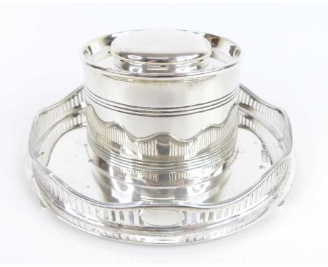 A circa 1900 silver capstan inkwell, the cylindricial ring turned body having hinged domed cover and dip pen holders, to a ci