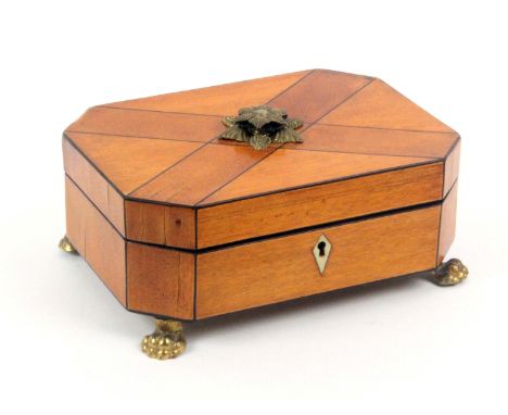 A satinwood small format sewing box, circa 1820, of cut corner rectangular form raised on four gilt lion paw feet, with diamo