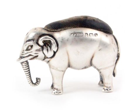 A silver figural pin cushion in the form of a standing elephant, Birmingham 1907 by Adie and Lovekin Ltd., 3.5cms high. From 