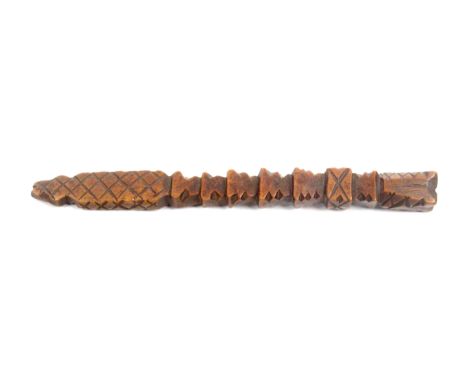 An early 19th Century fruitwood chip carved knitting stick, of eight graduated steps to a cross hatched terminal, 23.5cms.   