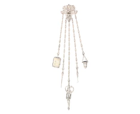 An elaborate silver chatelaine, the hook to a heavily cast mount pierced and decorated with a mask, cherubs, scrolls and myth