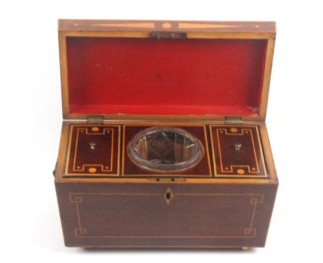 A mahogany tea caddy of sarcophagol form, circa 1820, the front and sides inlaid with boxwood lines, the latter with brass li