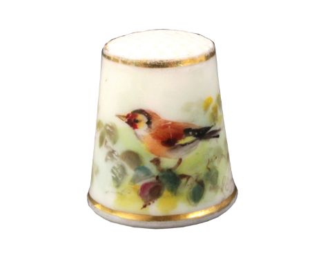A Royal Worcester porcelain puce mark thimble painted with a bird, on a leafy branch between gilt lines. From the collection 