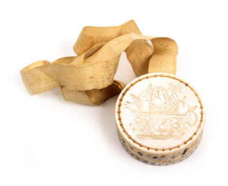 A mother of pearl disc form pin cushion, on original ribbon suspension, each side nicely engraved with a basket of fruit, 3.2