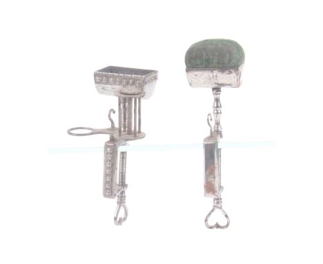 Two polished steel sewing clamps, comprising a multi-functional example, the rectangular floret mounted frame with reel, hook