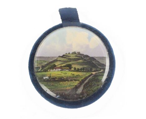 A rare reverse glass decorated disc form pin cushion, one side with an untitled view of Stonehenge, the other with a titled v