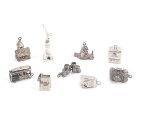 Stanhopes, nine white metal and silver charms with Stanhopes comprising a camera, hangman from Old +++ Road, Combe Martin / a